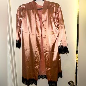 NWOT. Never worn. Pretty pink silk with black lace trim night cover up
